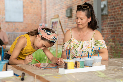 Museumbezoekers volgen een workshop in de tuin van museum M Leuven